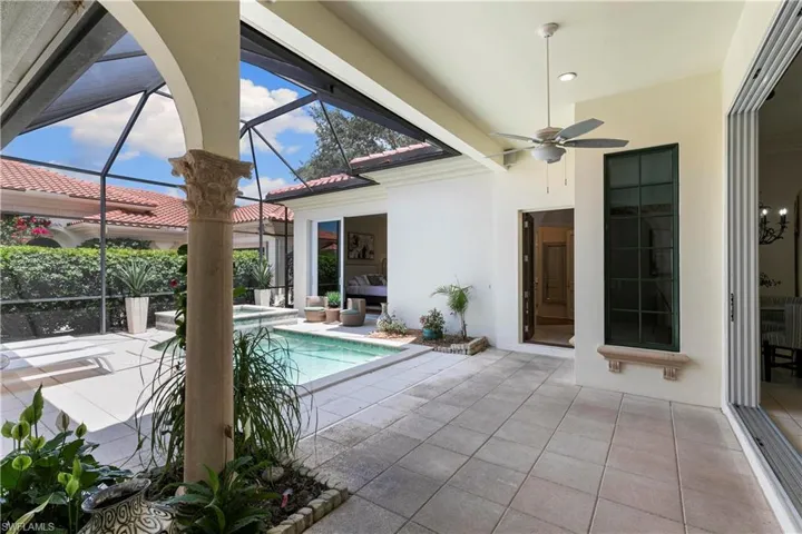 View of swimming pool with a patio, a lanai, and ceiling fan