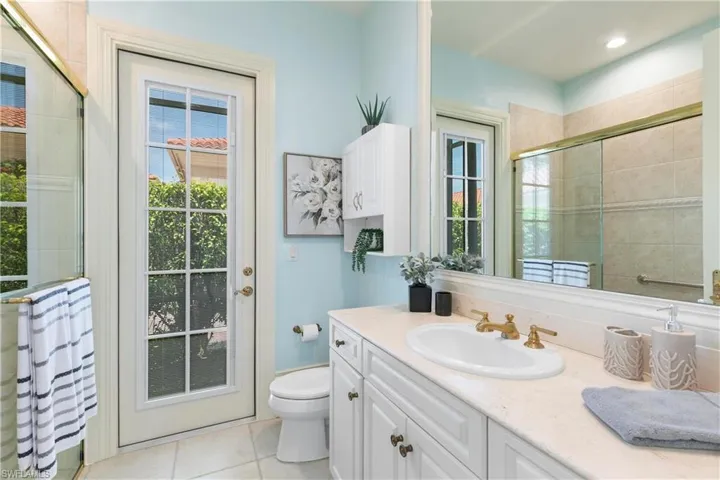 Bathroom with tile flooring, oversized vanity, and toilet