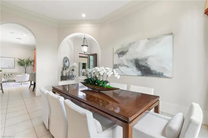 Dining area featuring ornamental molding and light tile floors