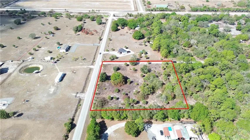 Aerial view of sparsely populated area featuring property boundaries highlighted