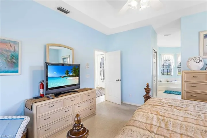 Primary Bedroom with Flat Screen tv and adjoining bathroom