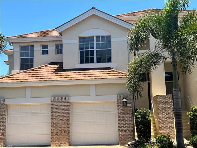 View of front of property with garage on right