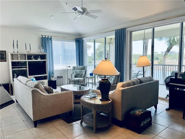 Living room featuring light tile flooring and water view