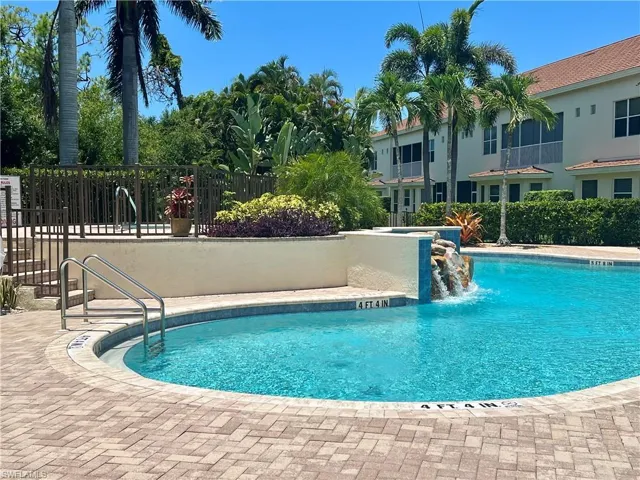 View of community pool with water feature