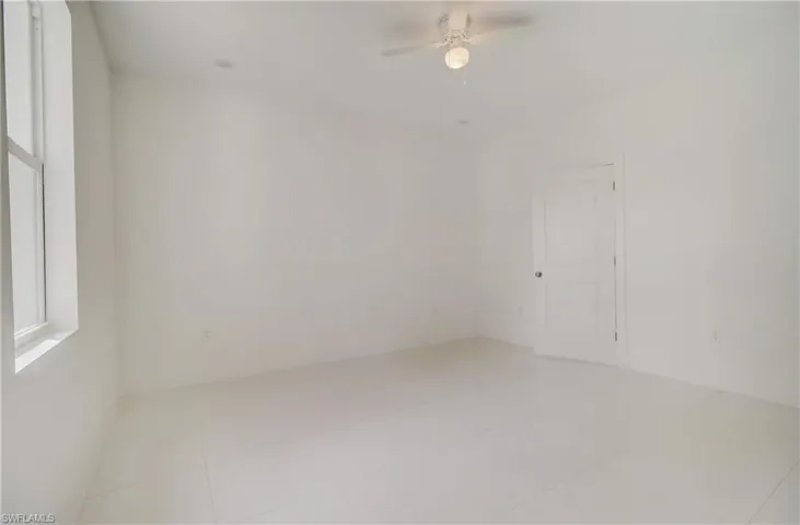 Spare room with tile patterned flooring and ceiling fan