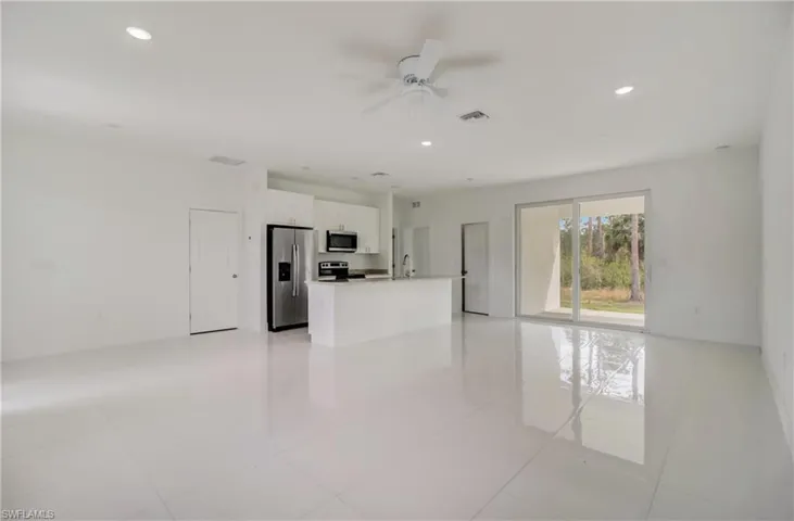 Unfurnished room featuring ceiling fan, light tile patterned floors, and sink