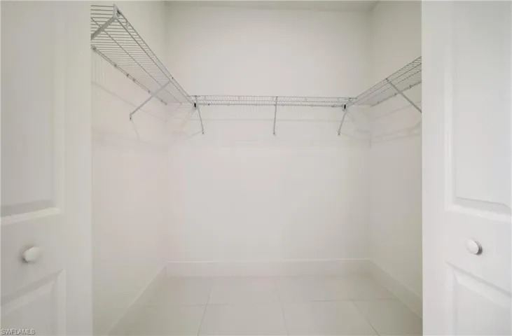 Walk in closet featuring light tile patterned floors