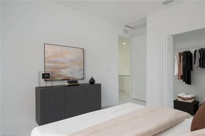 Tiled bedroom featuring a closet