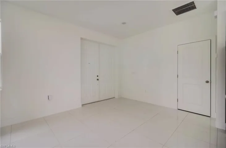 Spare room featuring light tile patterned floors