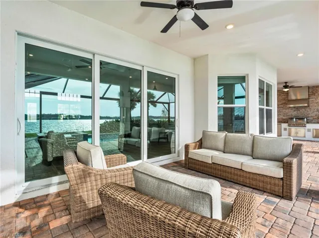 View of patio with an outdoor kitchen, area for grilling, ceiling fan, and an outdoor hangout areaVirtually enhanced
