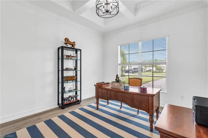 Office with beam ceiling, wood-type flooring, coffered ceiling, a notable chandelier, and crown moldingVirtually enhanced
