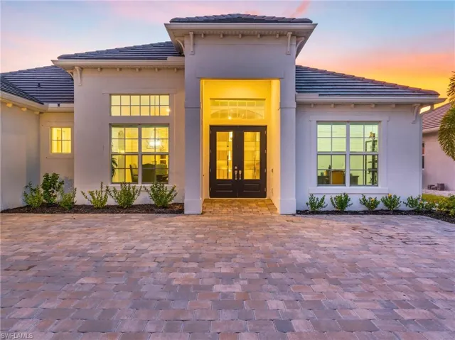 Exterior entry at dusk featuring french doorsVirtually enhanced
