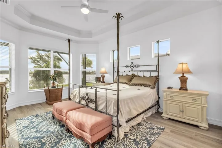 Bedroom with ornamental molding, ceiling fan, and light hardwood / wood-style flooringVirtually enhanced