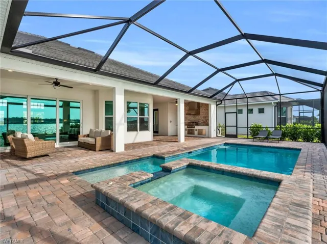 Rear view of house with an outdoor hangout area, glass enclosure, ceiling fan, and a patio areaVirtually enhanced
