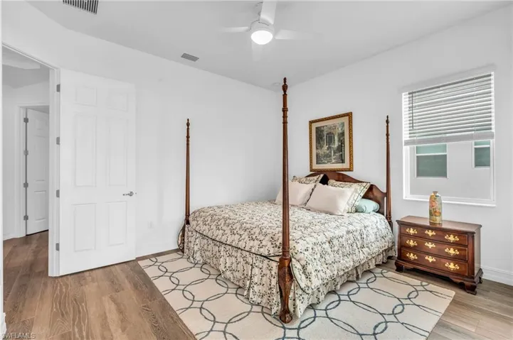 Bedroom featuring ceiling fan and light hardwood / wood-style floorsVirtually enhanced