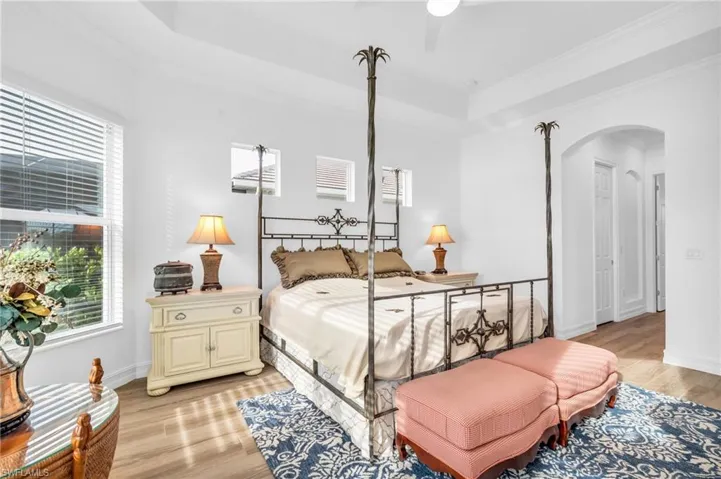 Bedroom featuring light wood-type flooring, ceiling fan, and crown moldingVirtually enhanced
