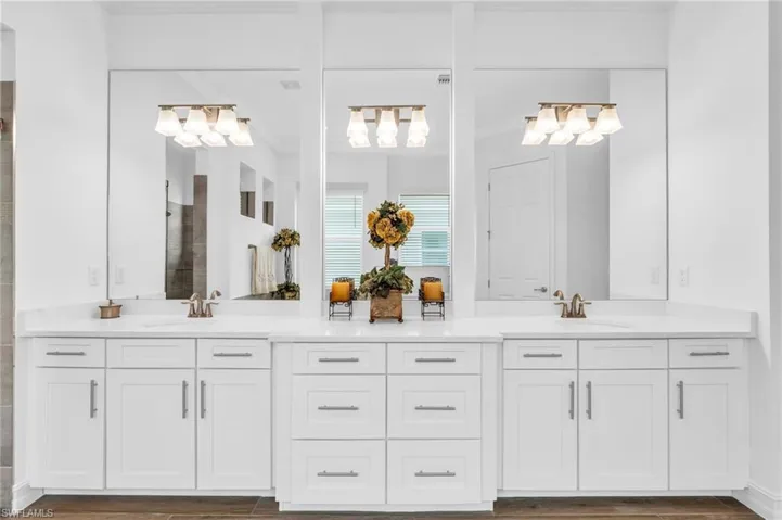 Bathroom with walk in shower, ornamental molding, vanity, and wood-type flooringVirtually enhanced