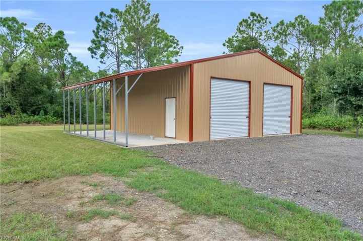 Garage featuring a lawn
