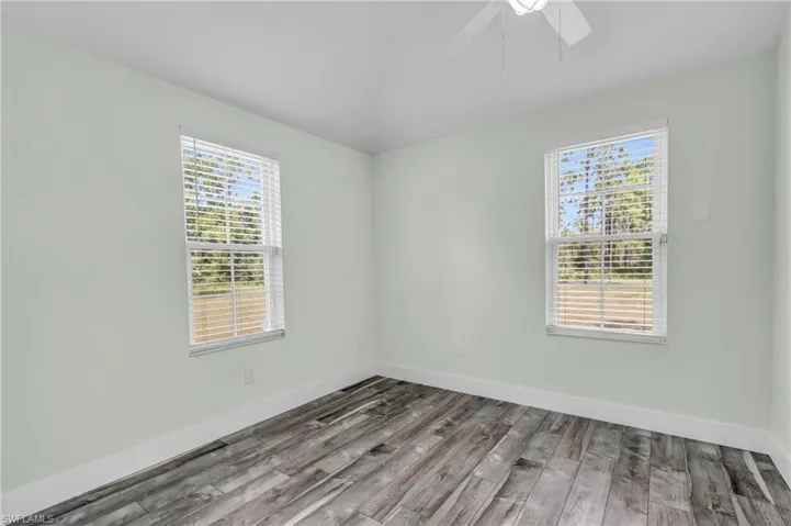 Empty room featuring hardwood / wood-style floors and ceiling fan