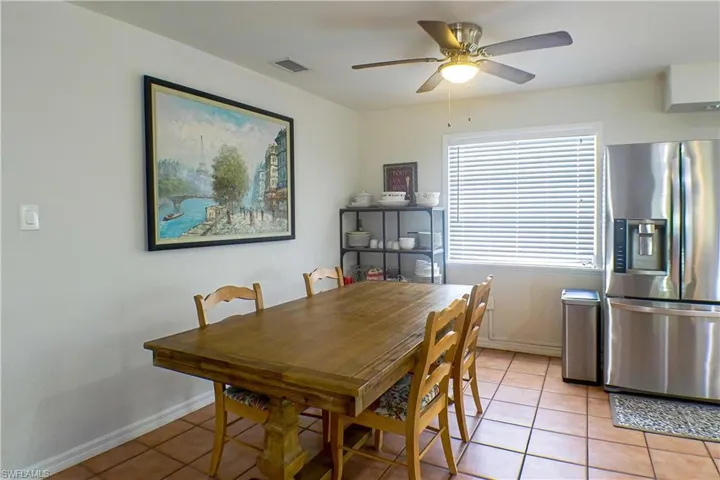 Dining area featuring ceiling fan and tile floors