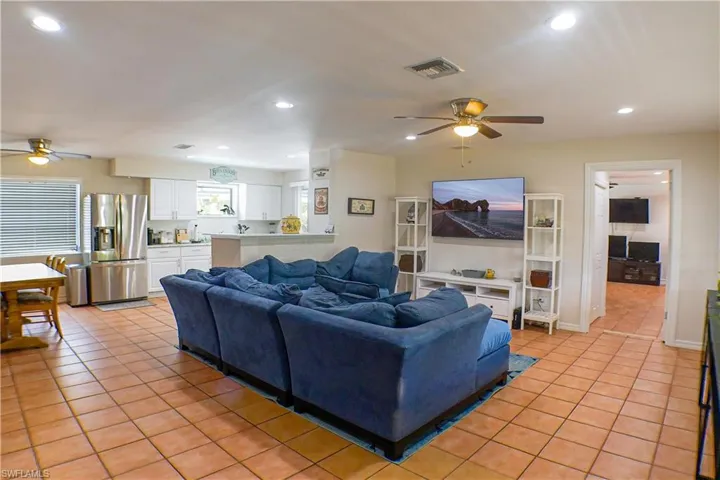 Living room with ceiling fan and tile floors