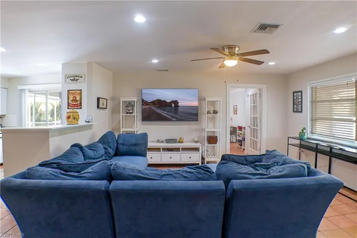 Living room with ceiling fan and tile floors