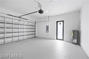 Garage featuring water heater and recessed lighting