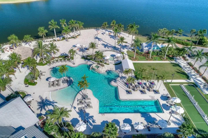 Pool - The resort style pool has a zero entry area, 2 lap lanes, waterfall feature, gated kiddie pool area, bocce ball courts, bathroom facilities, and access to the private beach area.