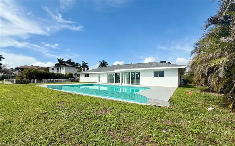 View of swimming pool with a fenced in pool, a lawn, and fence