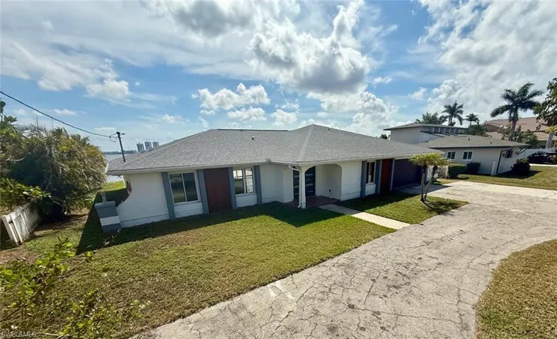 Single story home featuring concrete driveway, an attached garage, fence, a front yard, and stucco siding
