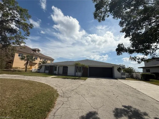 View of front of house featuring a garage, a front yard, and concrete driveway