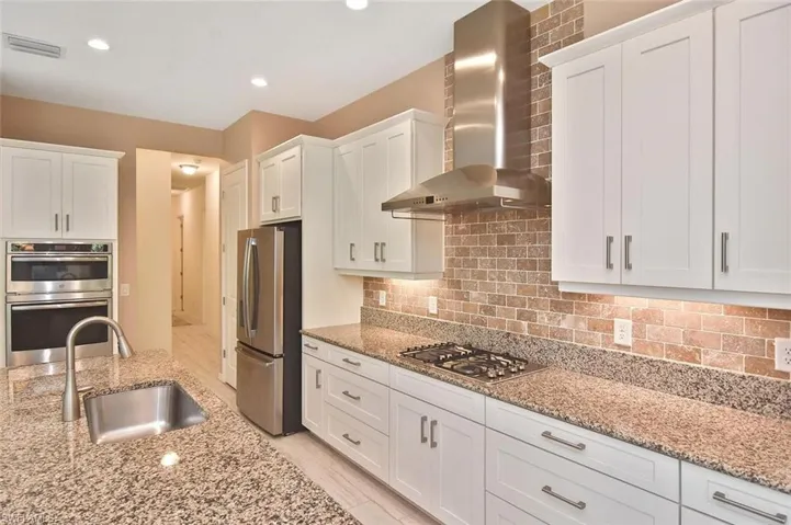 Beautifully designed Kitchen with granite counters, gas cooktop, and stainless appliances.
