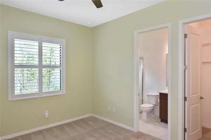 This Guest Room has an ensuite with a tiled walk-in shower with glass enclosure