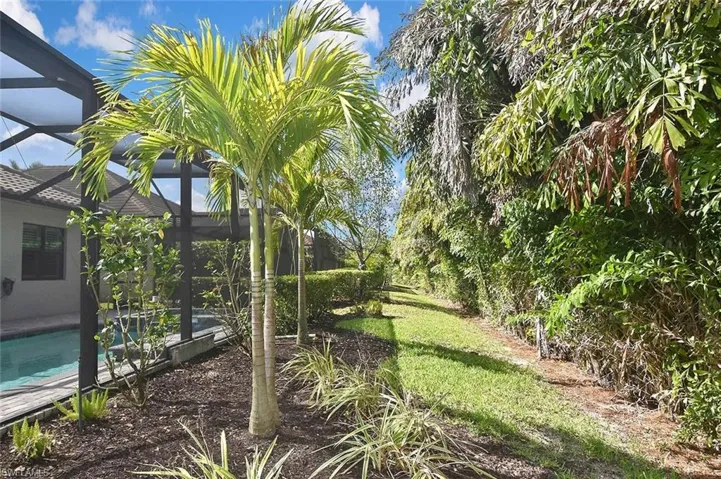 Meticulous tropical landscaping enhances this fantastic home