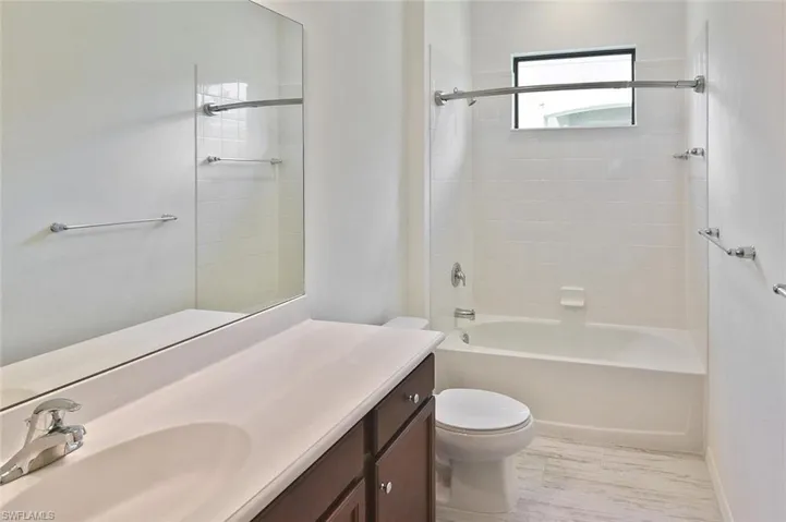 The Guest Bathroom with tiled tub/shower combination