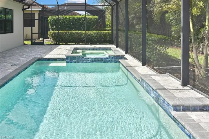 Generously proportioned pool deck, crystal clear pool and spa