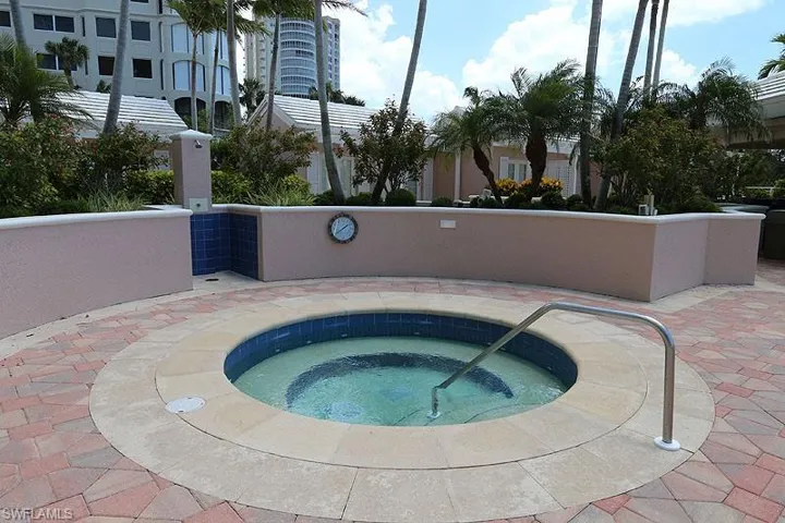 View of pool with a hot tub and patio surround