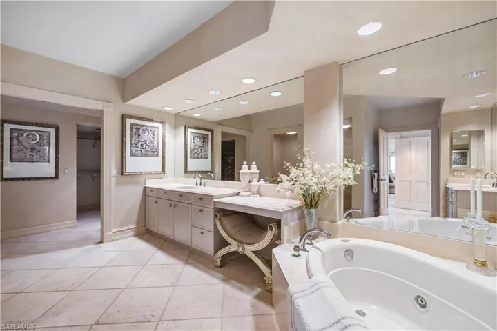 Master Bathroom featuring vanity, a bath, and recessed lighting