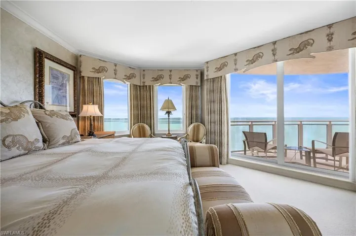 Mster Bedroom with carpet floors, a water view, and access to exterior