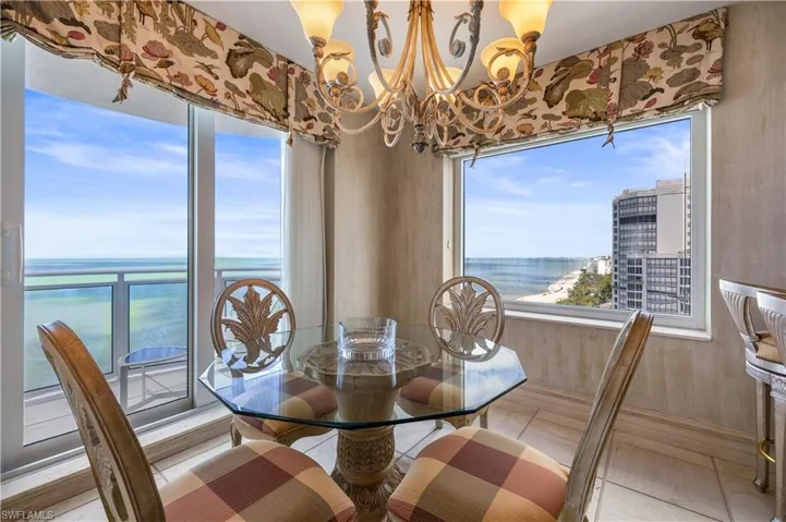 Tiled dining area with hanging lights and a water view