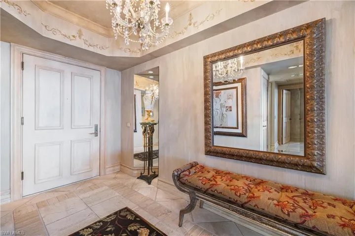 Condo Entry Hall featuring suspended lighting