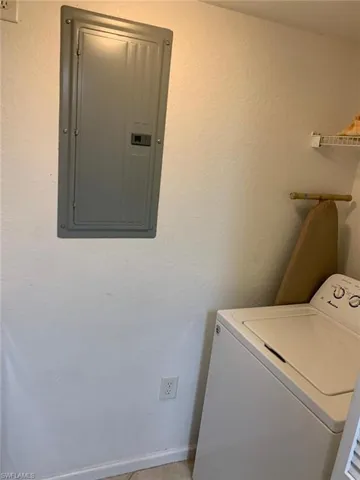 Laundry area with electric panel and washer / clothes dryer