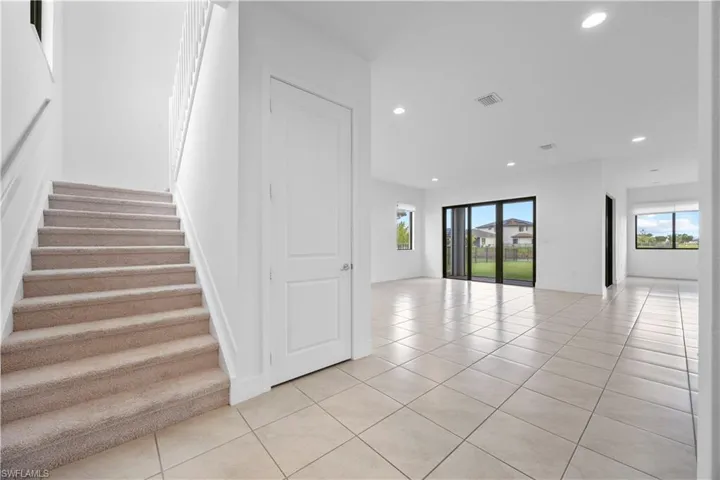 View of staircase to 2nd floor and main living area.
