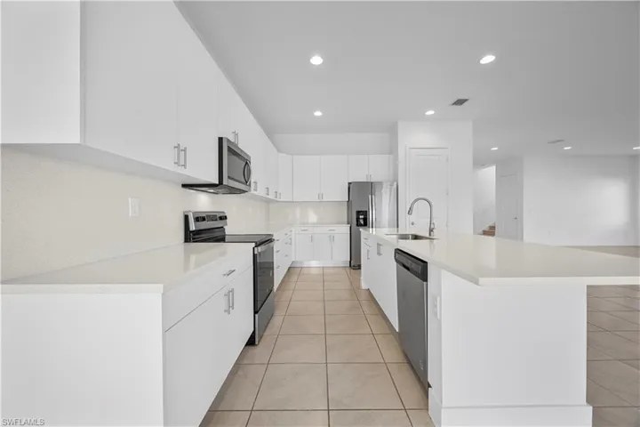 Kitchen featuring kitchen island with quartz countertops, modern cabinetry, and stainless steel appliances.