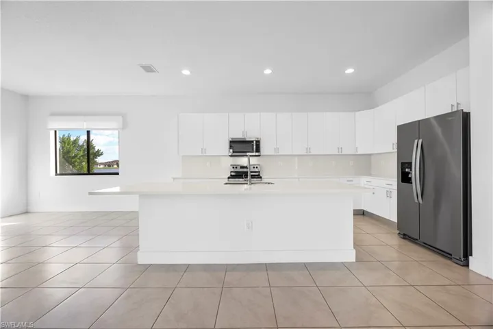 Kitchen featuring kitchen island with quartz countertops, modern cabinetry, and stainless steel appliances.