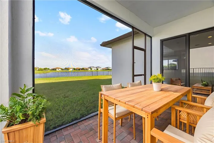 Virtually staged screened in lanai in backyard.