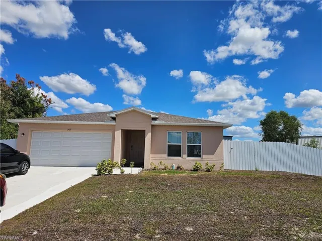 Single story home featuring a garage, stucco siding, driveway, and a shingled roof