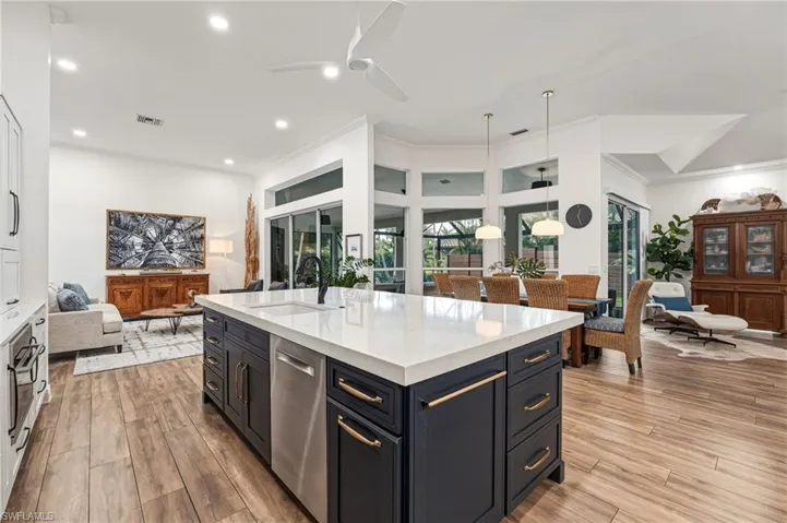 Transom windows invite an abundance of natural light to pour in, while soaring 14-foot ceilings grace this stunning showpiece throughout the entire home.