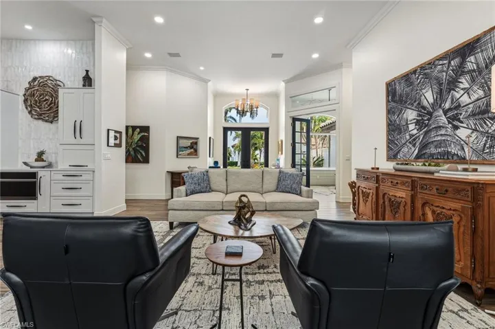 Impressive 8-foot double glass entry doors welcome you in, while to the right, a private office is elegantly enclosed by glass French doors.