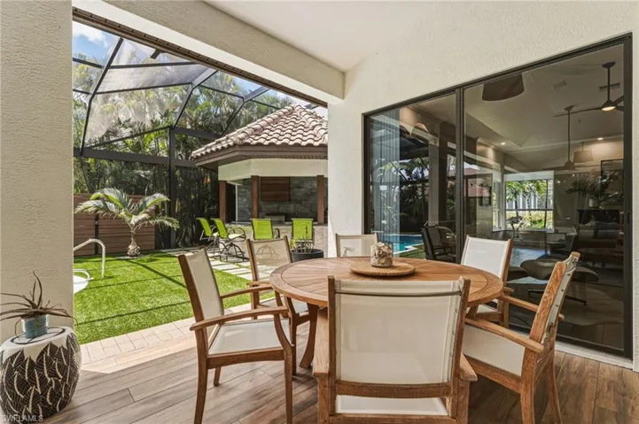A wonderful outdoor dining area embodies quintessential indoor-outdoor living, seamlessly blending comfort and style for effortless entertaining and relaxed everyday enjoyment.